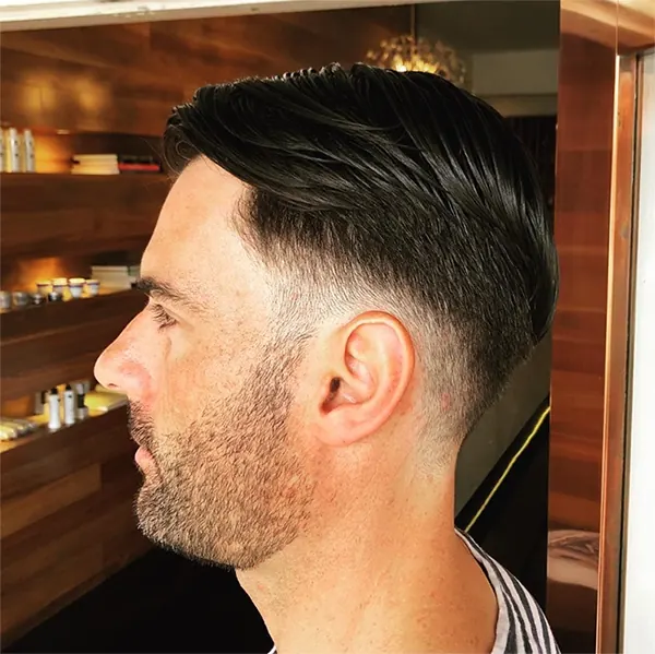Men's skin fade with a slick top